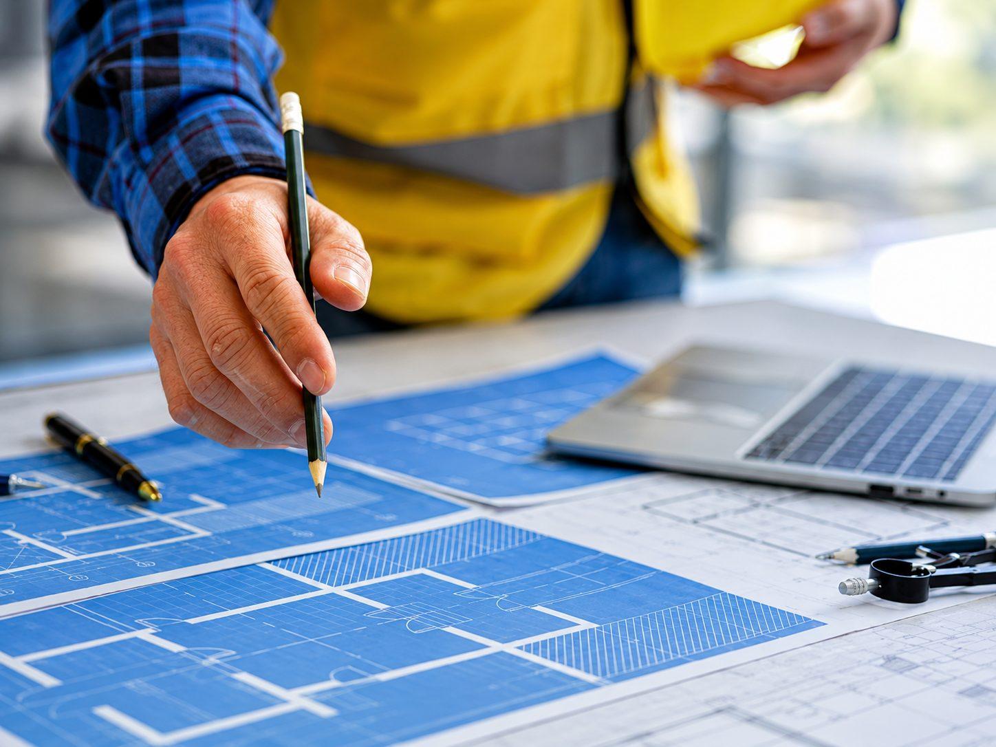 An engineer working over technical drawings
